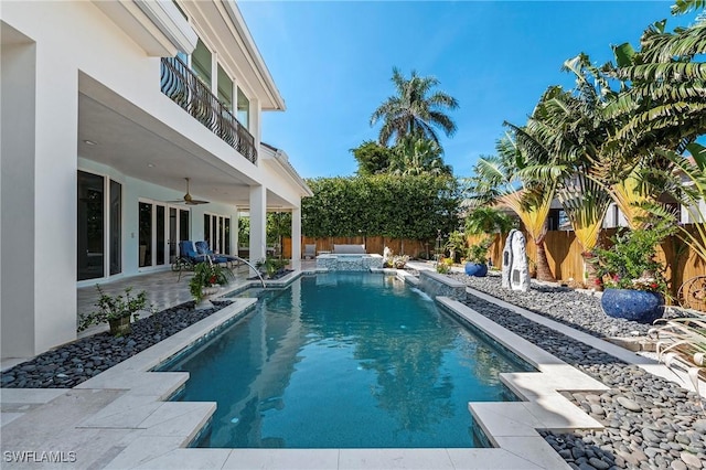 view of swimming pool featuring a patio area, ceiling fan, and an in ground hot tub