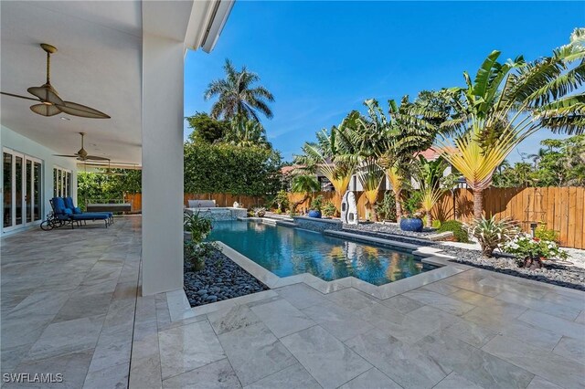 view of pool with a patio and ceiling fan