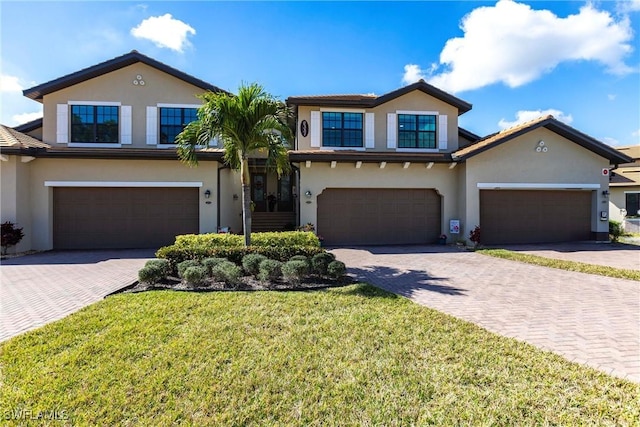 view of front of house with a garage and a front yard