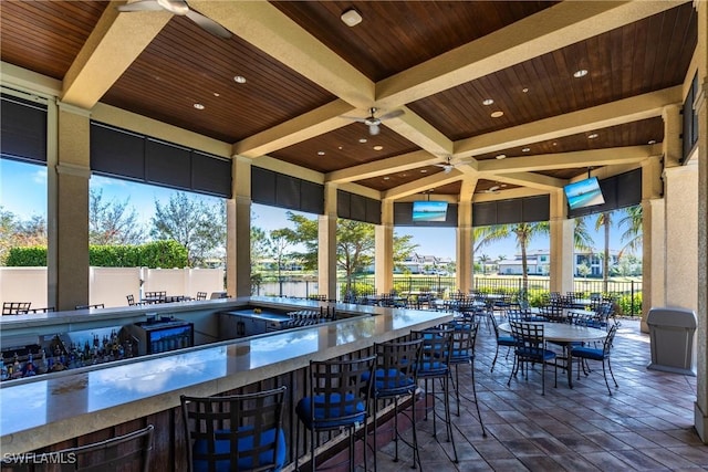 view of patio / terrace with exterior bar and ceiling fan