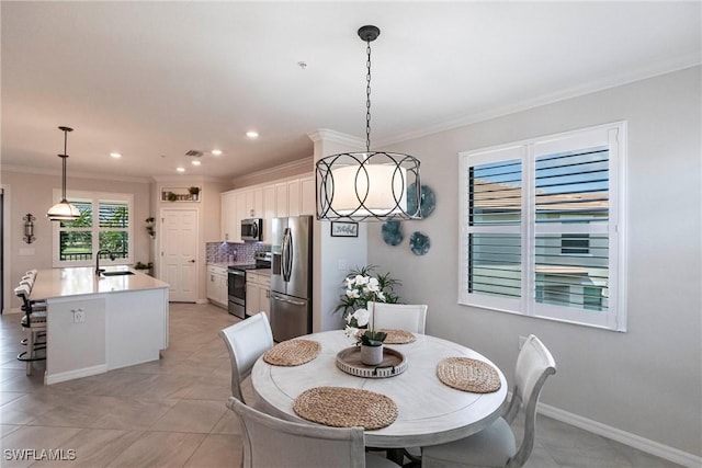 tiled dining space featuring sink and ornamental molding