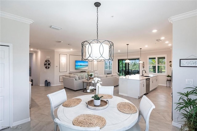 dining room with an inviting chandelier, sink, ornamental molding, and light tile patterned flooring