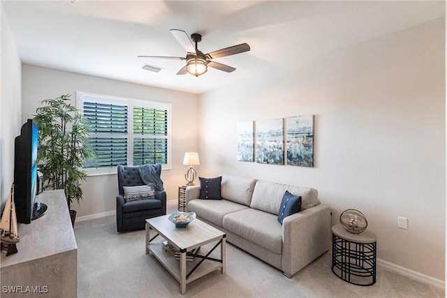 carpeted living room with ceiling fan