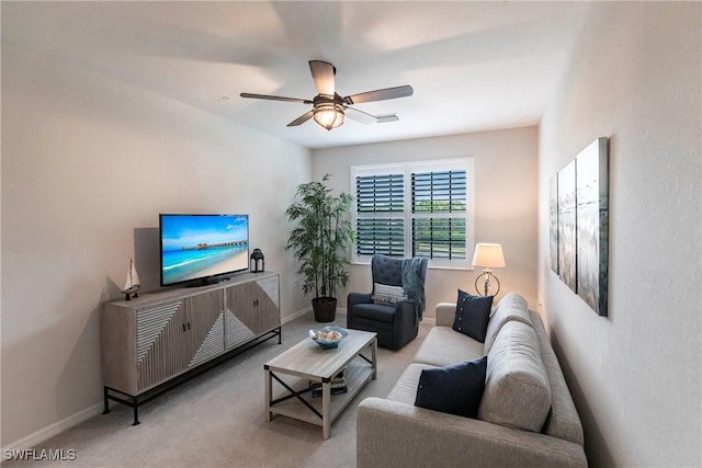 carpeted living room with ceiling fan