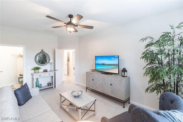 living room featuring light colored carpet and ceiling fan