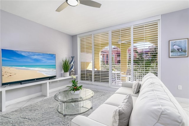 tiled living room with floor to ceiling windows and ceiling fan