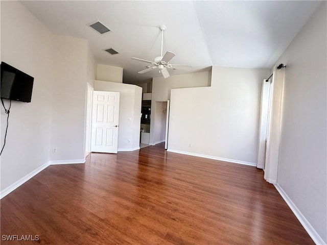 unfurnished living room featuring lofted ceiling, dark hardwood / wood-style floors, and ceiling fan