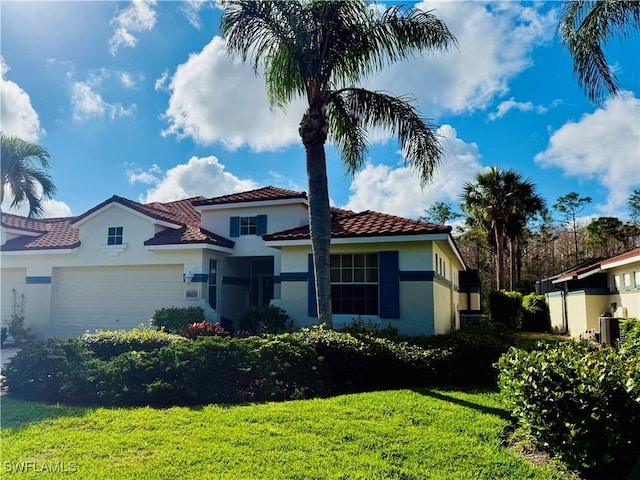 mediterranean / spanish-style home with a garage and a front yard