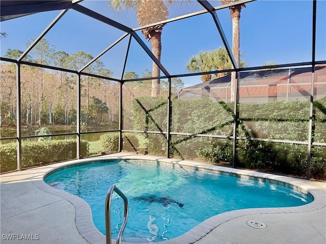 view of pool with glass enclosure