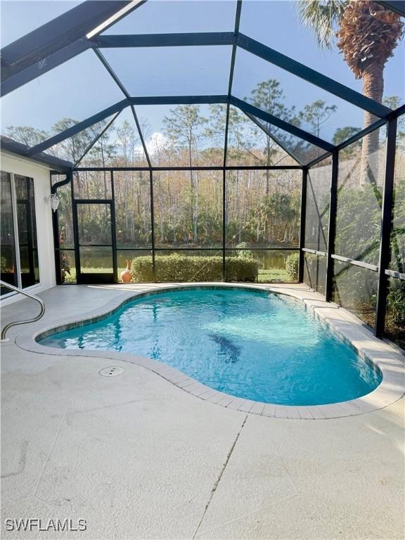 view of pool featuring a lanai and a patio area