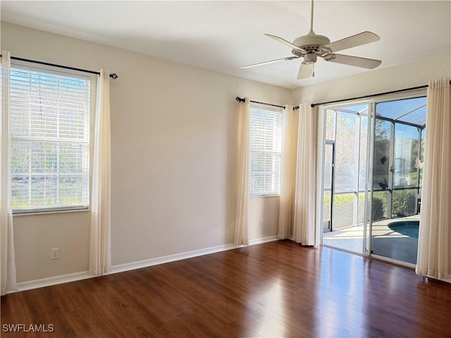 empty room featuring ceiling fan and dark hardwood / wood-style flooring