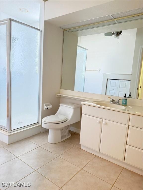 bathroom featuring vanity, toilet, a shower with shower door, and tile patterned flooring