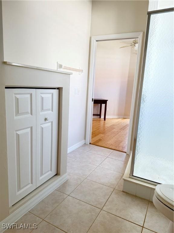 bathroom with ceiling fan, tile patterned floors, and toilet