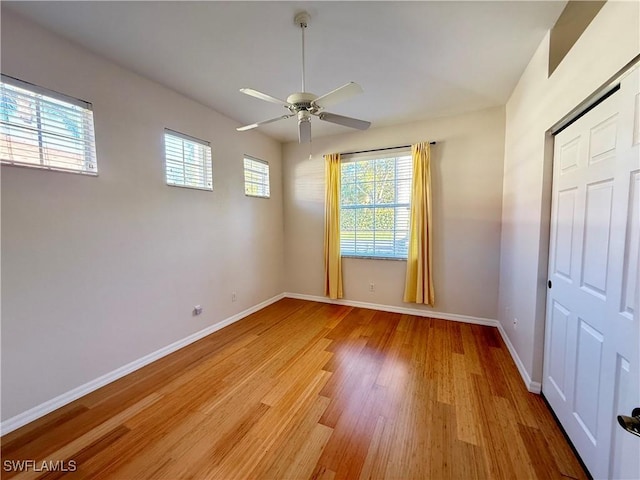 empty room with light hardwood / wood-style floors and ceiling fan