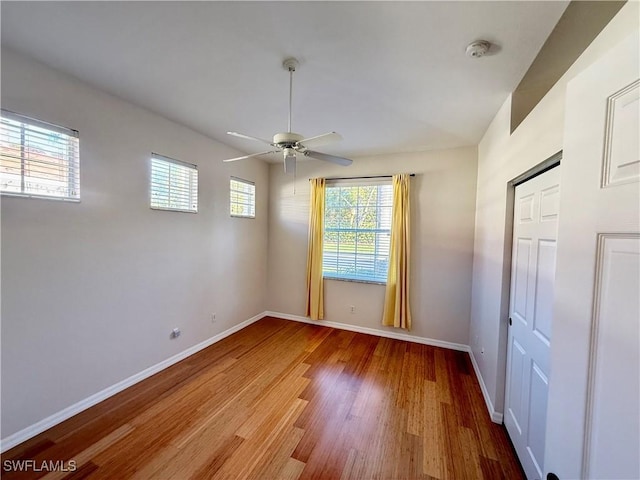 unfurnished room featuring hardwood / wood-style floors and ceiling fan