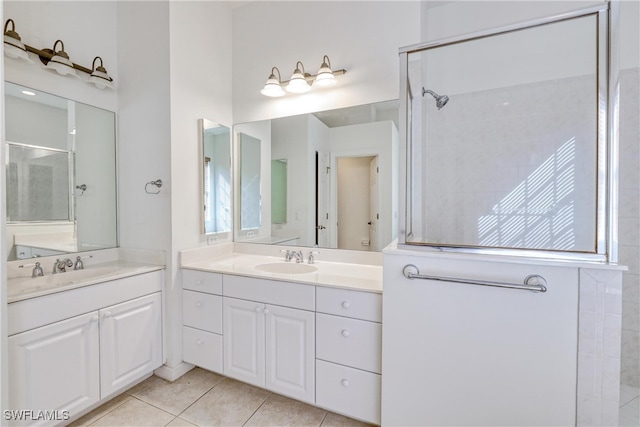 bathroom with tile patterned floors, vanity, and a shower