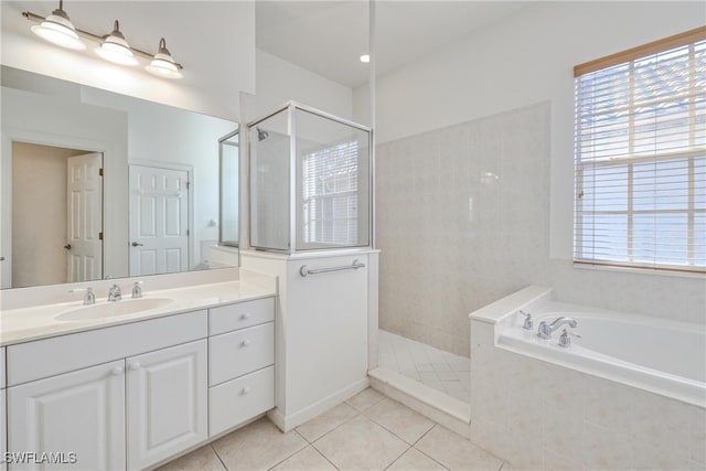 bathroom with independent shower and bath, vanity, and tile patterned floors