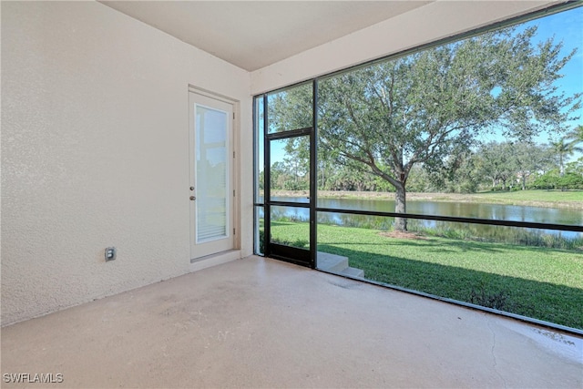 unfurnished sunroom with a water view