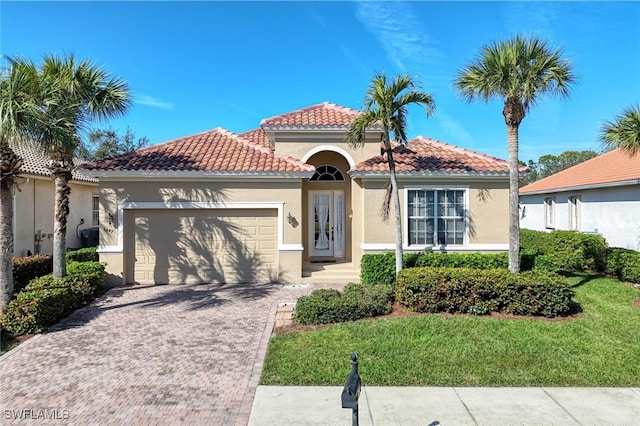 mediterranean / spanish-style house with a garage and a front yard