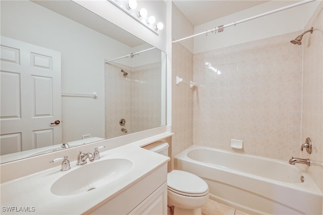 full bathroom featuring tiled shower / bath combo, vanity, and toilet