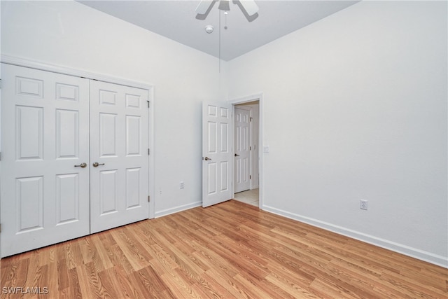 unfurnished bedroom featuring light hardwood / wood-style flooring, a closet, and ceiling fan