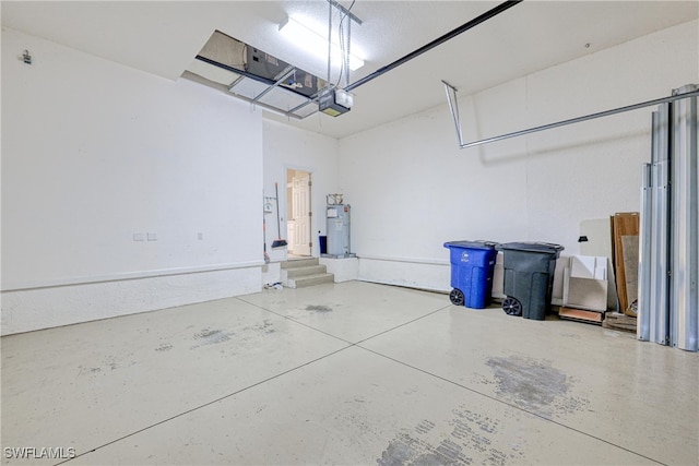 garage featuring a garage door opener and water heater