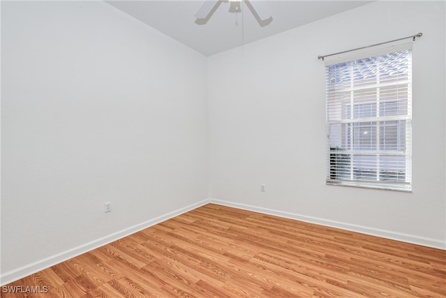 spare room featuring ceiling fan, light hardwood / wood-style floors, and a healthy amount of sunlight