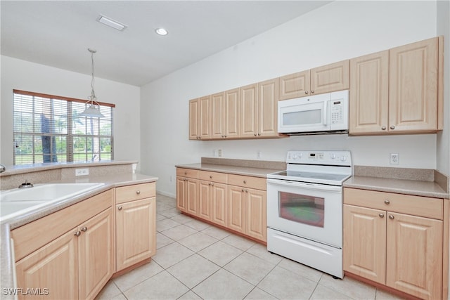 kitchen featuring white appliances, light tile patterned flooring, decorative light fixtures, and light brown cabinets