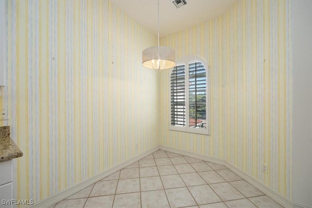 1575 Clermont Dr Unit N-201, Naples, FL 34109 - unfurnished dining area with light tile patterned flooring and baseboards