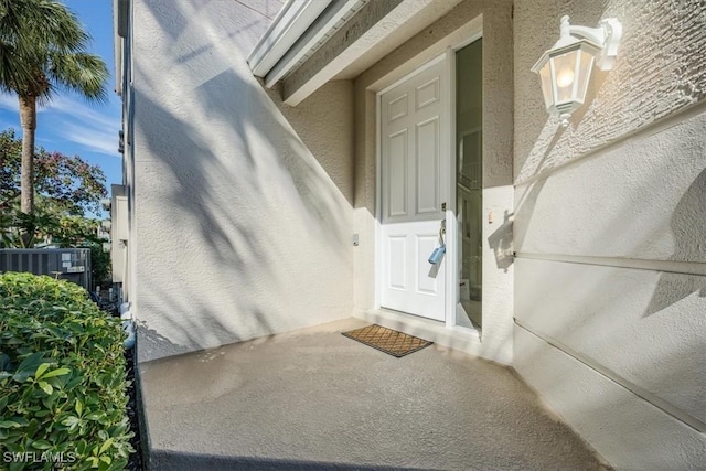 doorway to property featuring central air condition unit