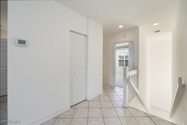 1575 Clermont Dr Unit N-201, Naples, FL 34109 - hall featuring an upstairs landing, light tile patterned flooring, and recessed lighting