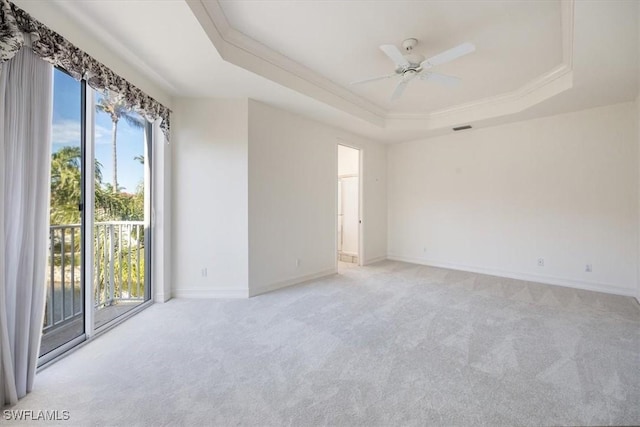 1575 Clermont Dr Unit N-201, Naples, FL 34109 - spare room with a raised ceiling, light colored carpet, a ceiling fan, and crown molding