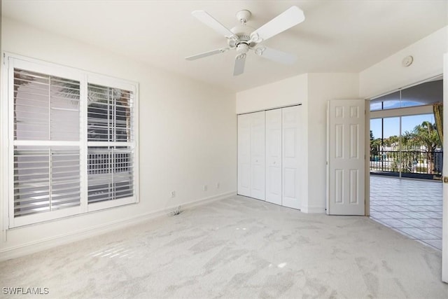 1575 Clermont Dr Unit N-201, Naples, FL 34109 - unfurnished bedroom featuring carpet flooring, a closet, and a ceiling fan