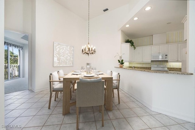 1575 Clermont Dr Unit N-201, Naples, FL 34109 - dining area with high vaulted ceiling, light tile patterned flooring, a chandelier, and recessed lighting