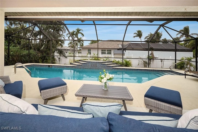 view of swimming pool with a patio, an outdoor living space, and glass enclosure