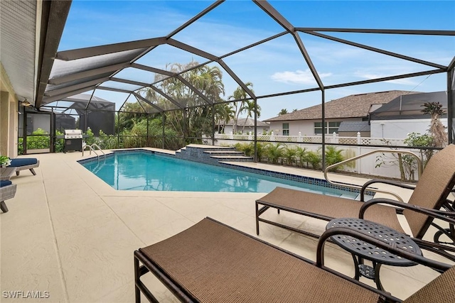 view of swimming pool featuring a patio, a lanai, and grilling area