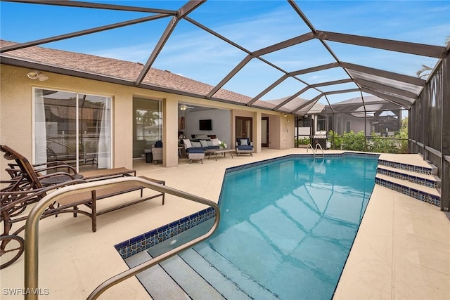 view of pool with a lanai, an outdoor hangout area, and a patio area