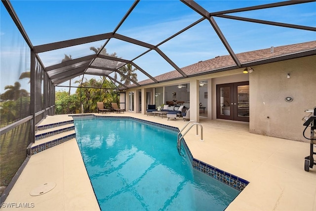 view of swimming pool with a patio area, outdoor lounge area, french doors, and glass enclosure