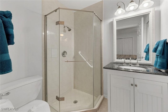 bathroom with toilet, a shower with door, and vanity