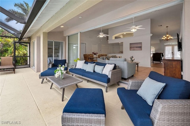 view of patio / terrace with high vaulted ceiling, light tile patterned flooring, and ceiling fan with notable chandelier