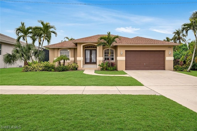 view of front facade with french doors, a front lawn, and a garage