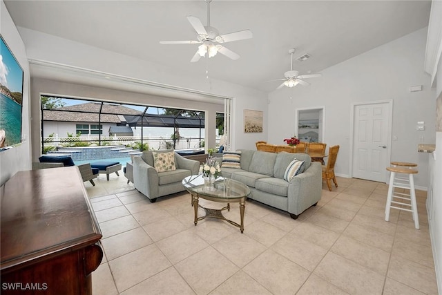 tiled living room with high vaulted ceiling and ceiling fan