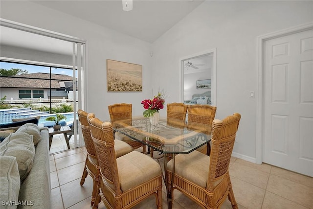 tiled dining room with lofted ceiling