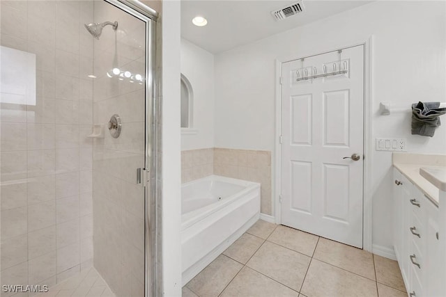 bathroom with plus walk in shower, tile patterned flooring, and vanity