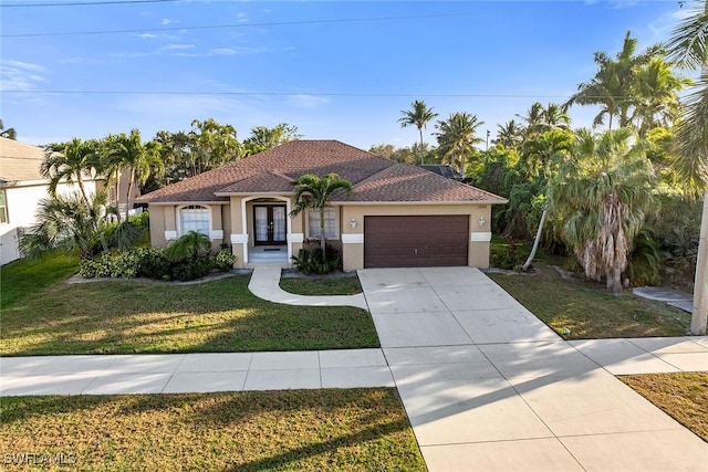 mediterranean / spanish-style home featuring a garage and a front yard