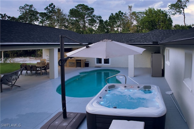 view of pool with a hot tub and a patio