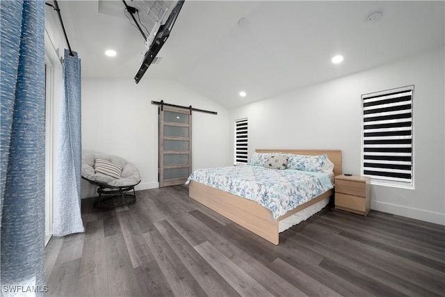 bedroom with dark hardwood / wood-style floors, lofted ceiling, and a barn door