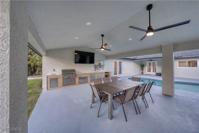 view of patio featuring exterior kitchen, area for grilling, ceiling fan, and french doors