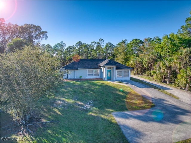 view of front of house with a garage and a front yard