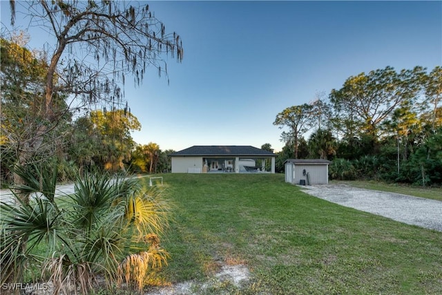 ranch-style house featuring a shed and a front yard